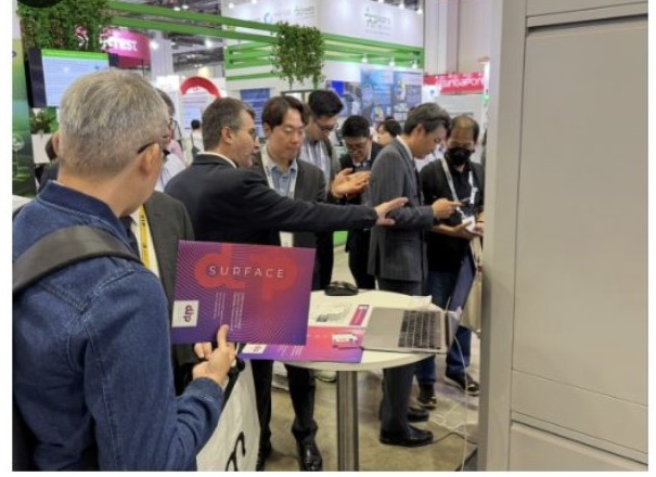 Attendees reviewing the DIP-View SURFACE brochure — SEMICON Southeast Asia 2025
